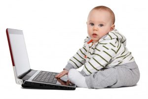 portrait-of-baby-boy-playing-on-laptop